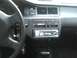 2003 Ford Crown Victoria - The interior of a vehicle shows the dashboard, steering wheel, and an aftermarket stereo system with a digital clock displaying 2:27.