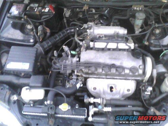 Engine bay with radiator, battery, and engine components visible