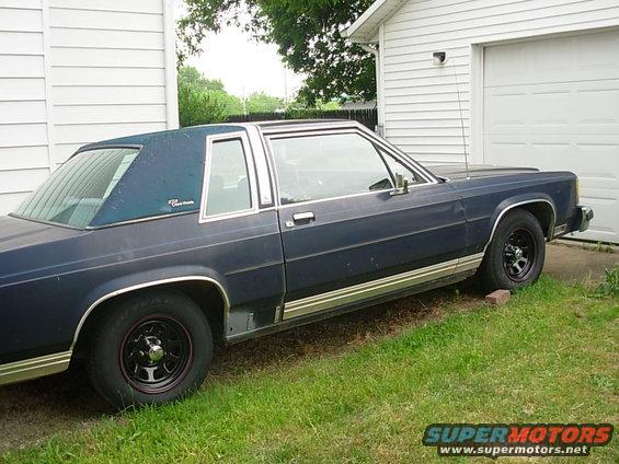 Dark blue 1985 Ford Crown Victoria LTD coupe side view with vinyl roof