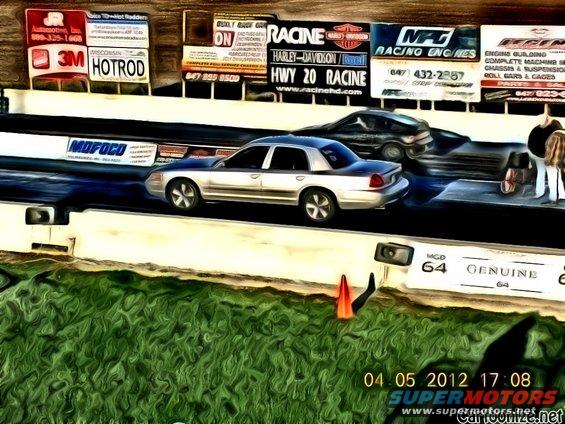 Silver sedan on drag strip, 2003 Ford Crown Victoria