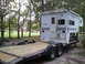 1967 Ford Mustang - A truck camper labeled "Weekender" is loaded onto a flatbed trailer in a wooded area.