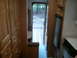 1967 Ford Mustang - View from inside an RV hallway, showing cabinets, a fridge, and the outdoors through an open door.