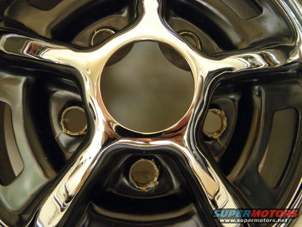 Chrome wheel with five spokes and a central hub opening