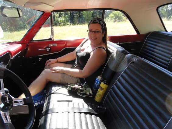 Interior of a 1964 Ford Fairlane with a woman in the passenger seat