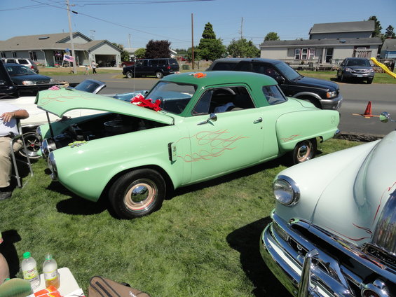 Light green coupe with flame decals and hood open