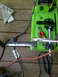 1989 Ford Bronco - Metal part being cut on a chop saw with tools and a speed square on a wooden surface.