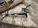 1988 Ford Bronco - Dashboard and steering column removed from a vehicle and placed on concrete for repair or replacement.