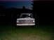 1967 Ford F-250 - A 1967 Ford F-250 truck is seen from the front, parked in a grassy field at twilight.
