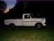 1967 Ford F-250 - A white 1967 Ford F-250 pickup truck sits on a grassy area as the sky darkens.