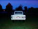 1967 Ford F-250 - 1967 Ford F-250 pickup truck seen from the rear at twilight.