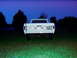 1967 Ford F-250 - A white Ford pickup truck is parked in a grassy field at twilight, showing its rear end.