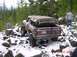 1989 Ford Bronco - A modified Ford Bronco navigates a challenging, snow-covered terrain with several onlookers present.