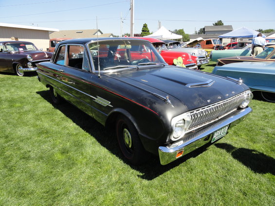 Black 1964 Ford Fairlane 4-door sedan with red pinstripes and chrome grille