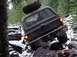 1989 Ford Bronco - Chevrolet K5 Blazer tackling a difficult off-road obstacle with snow and rocks.