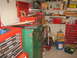 1994 Ford Bronco - A cluttered workshop scene features multiple toolboxes, shelves filled with tools, and various storage containers.