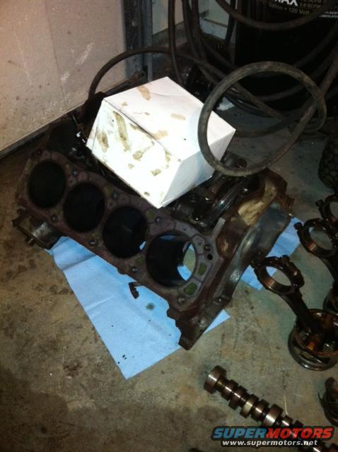 Engine block with pistons and crankshaft on floor