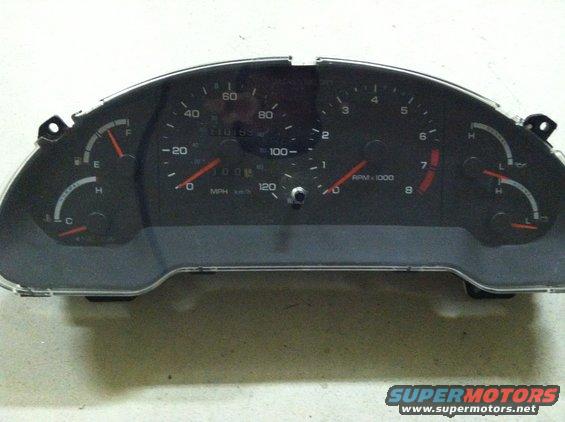 car dashboard gauges with speedometer and tachometer