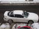 1995 Ford Probe - A white 1995 Ford Probe is partially covered in snow, with another red vehicle visible below it.