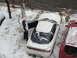 1995 Ford Probe - A white coupe sits in the snow with its driver's door open, parked beside a red vehicle.