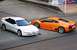 1995 Ford Probe - A white 1995 Ford Probe is parked next to a bright orange Lamborghini.