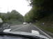 1995 Ford Probe - Driving on a road through a forested area with several vehicles ahead.