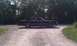 1991 Mercury Grand Marquis - This 1991 Mercury Grand Marquis is seen from the side, parked on a gravel road with trees in the background.