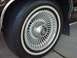 1991 Mercury Grand Marquis - Close-up of a 1991 Mercury Grand Marquis wheel a chrome hubcap with the Mercury logo and a whitewall tire.