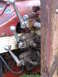 1988 Ford Bronco - Hydraulic control levers and valves on a tractor. The red bodywork shows some wear and tear.