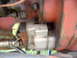 1988 Ford Bronco - Hydraulic pump assembly on red machinery, possibly from a tractor or industrial equipment.