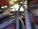 1988 Ford Bronco - Close-up view of engine hoses and red metal components, likely from a tractor or heavy machinery.