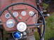 1988 Ford Bronco - Close-up of a tractor's interior, focusing on the dashboard instrumentation and steering wheel.