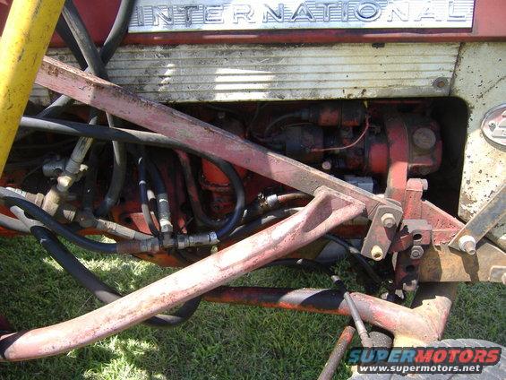 Close-up of an International Harvester tractor's engine bay and hydraulic lines