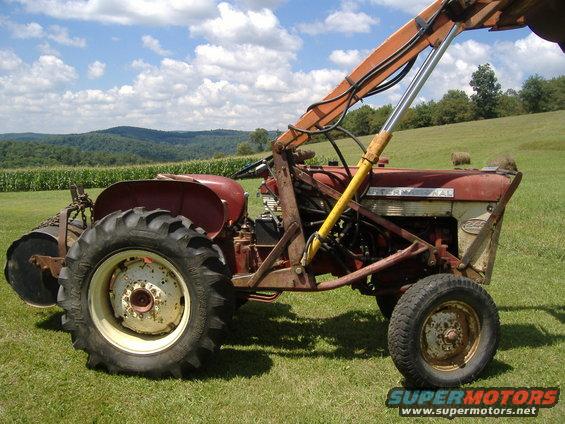 Red tractor with front loader, side view. Text 'INTERNATIONAL' visible