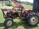 1988 Ford Bronco - This International Harvester tractor, equipped with a front loader, is seen from the side in a grassy field.
