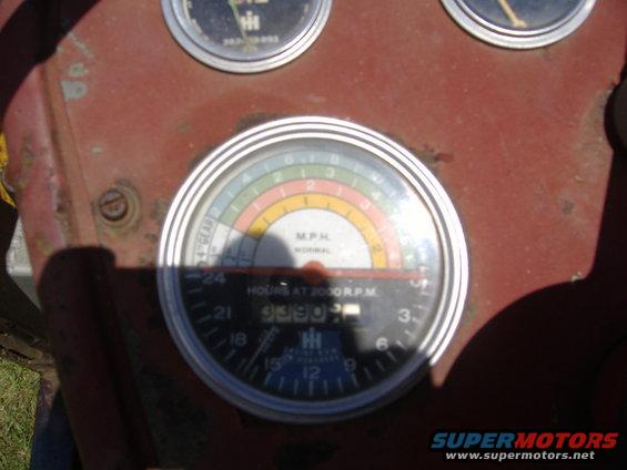 Tractor dashboard with tachometer and MPH gauge showing 5330 hours