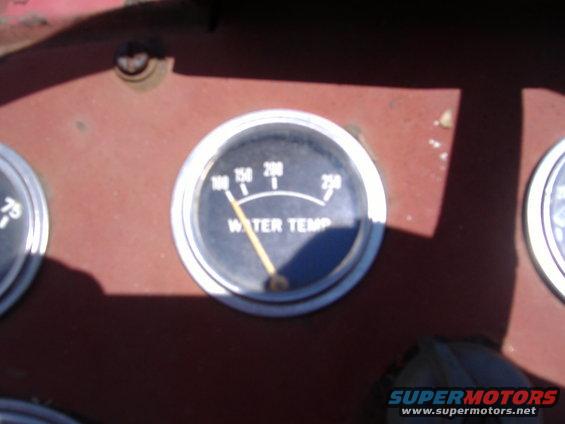 Close-up of a water temperature gauge and another gauge on a vehicle's dashboard