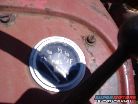 Close-up of a fuel gauge with markings for 1/4, 1/2, 3/4, and F