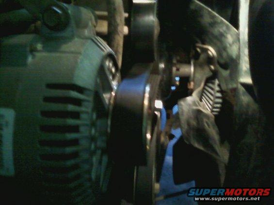 Close-up of vehicle's alternator and serpentine belt system