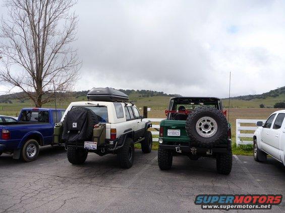 White 1985 Toyota 4Runner with roof box and spare tire on rear