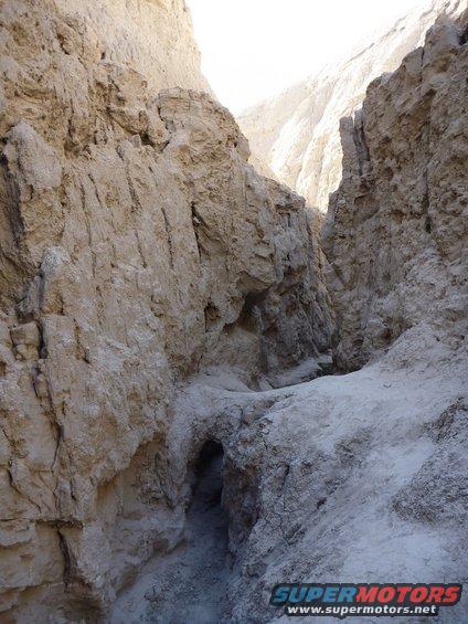 Desert canyon with narrow passage and rock formations