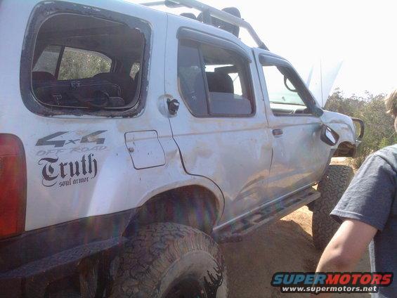 Silver SUV with "4x4 OFF ROAD Truth soul armor" decals on the rear quarter panel. Hood is open, and the rear window is missing