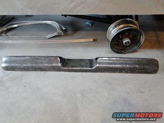 Chrome bumper and a chrome wheel on a concrete floor