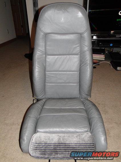 Gray leather car seat with perforated headrest and striped fabric base