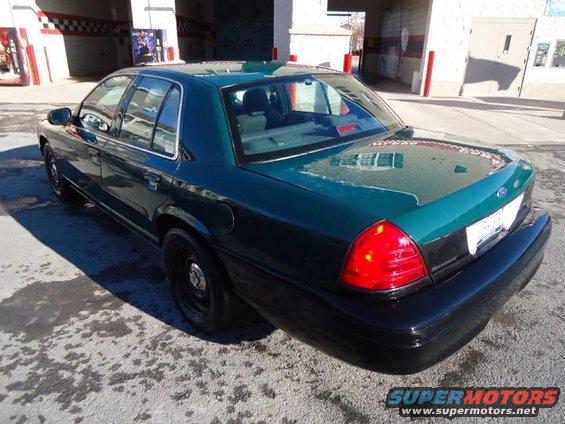 Dark green 2003 Ford Crown Victoria sedan, rear 3/4 view