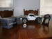 1988 Ford Bronco - A remote control truck and its accessories are displayed on a wooden table.
