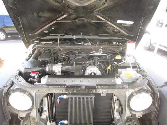 Jeep Wrangler engine bay with aftermarket radiator and engine components