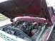 1979 Ford F-150 - The engine bay of a red 1979 Ford F-150 pickup truck is shown with the hood raised.