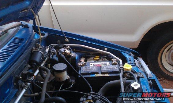 1991 Ford Festiva engine bay showing battery, brake fluid reservoir, and air intake