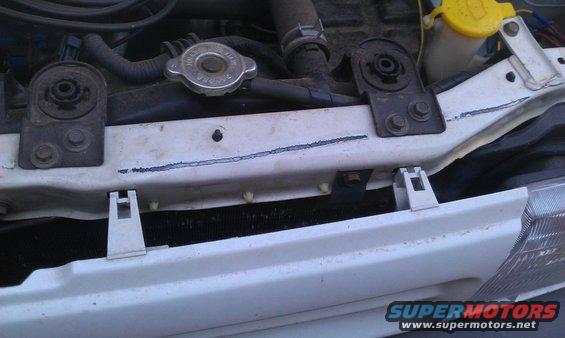 White radiator support with blue line marking and SuperMotors logo