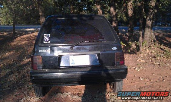 Rear view of a black 1991 Ford Festiva parked outdoors